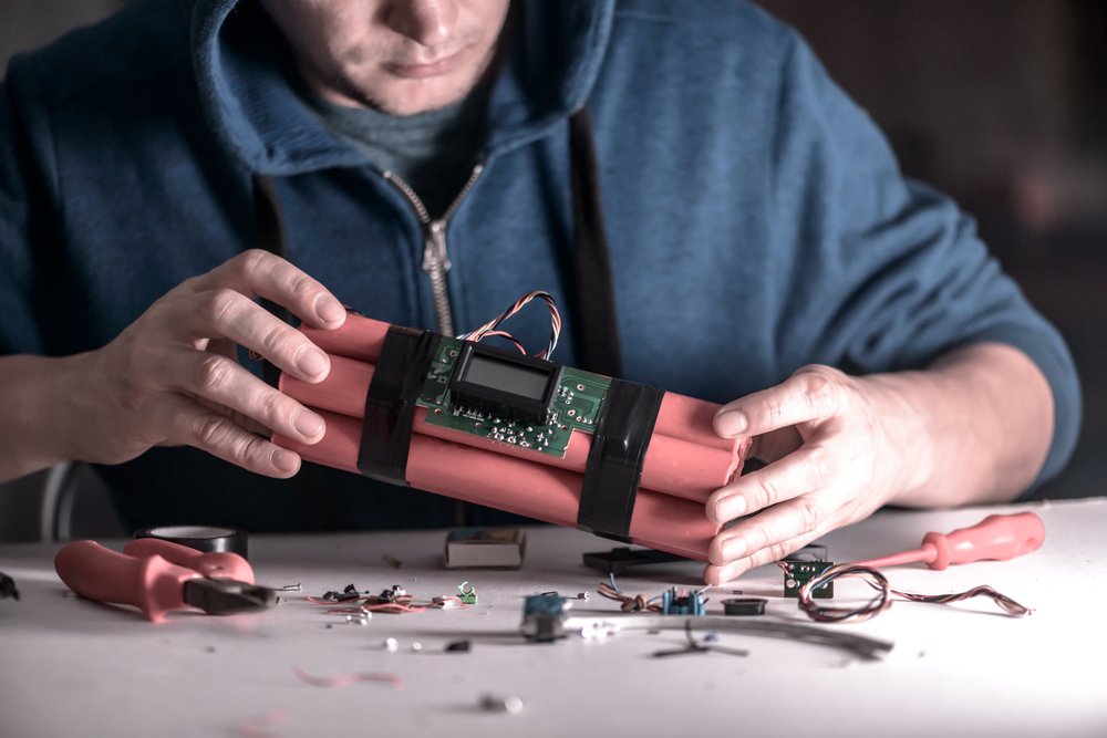 Man assembling a bomb as an example of possession of destructive device materials per Penal Code 18720 PC