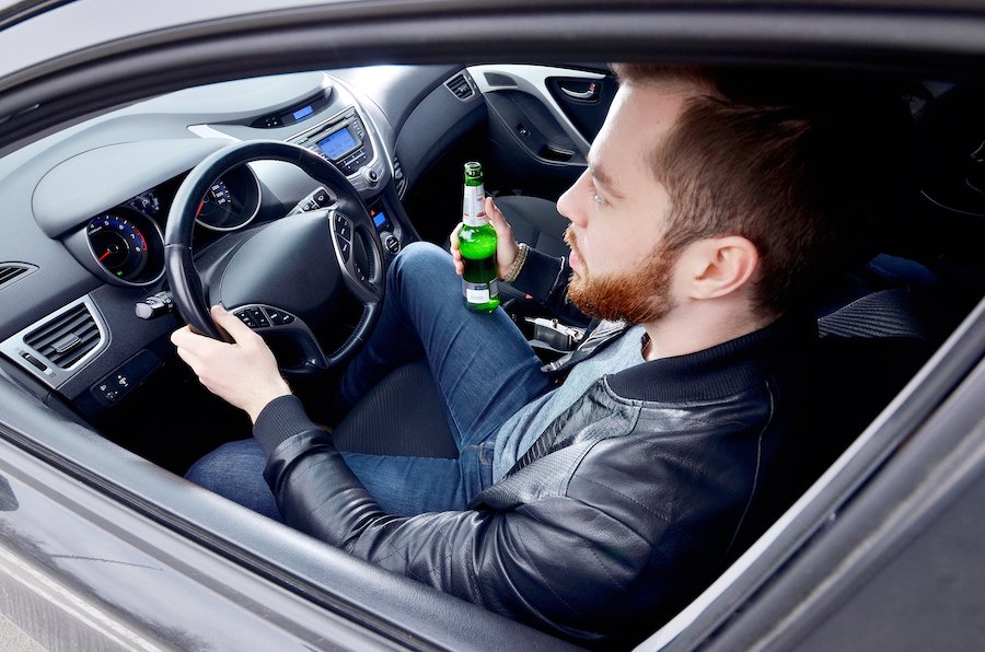 Driver holding a beer bottle