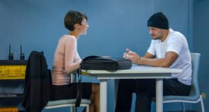 Criminal defendant with public defender at a table