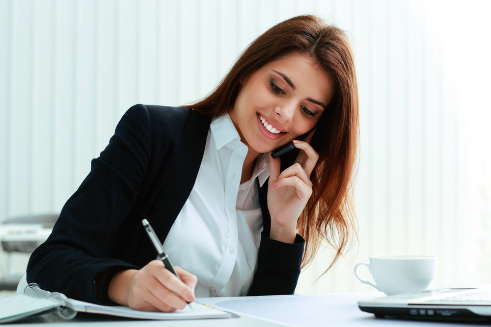 Smiling receptionist taking notes