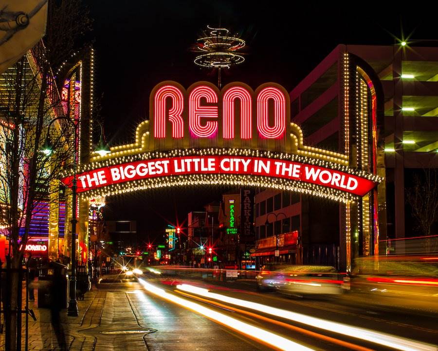 Vista nocturna de la señal de Reno que dice "la ciudad más pequeña del mundo"