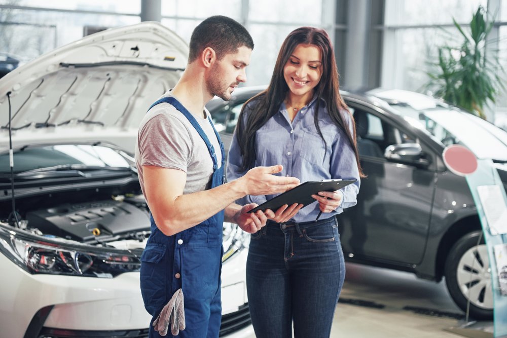 Mechanic showing a client an estimate.