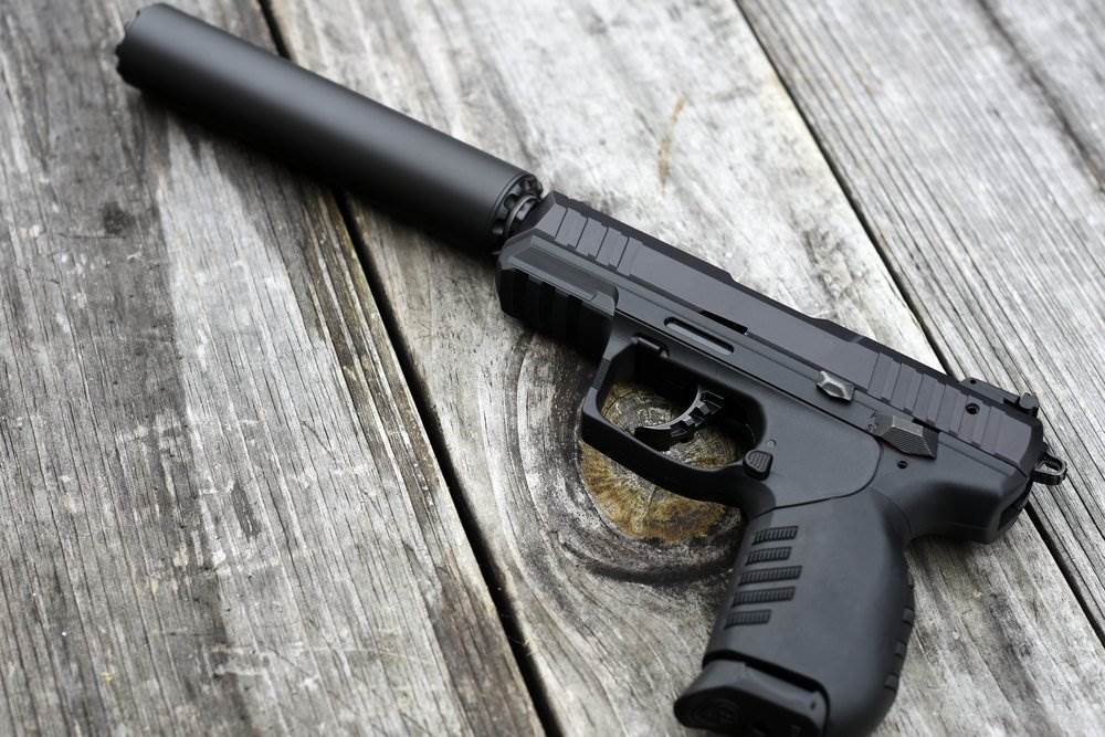 A pistol with a silencer attached.