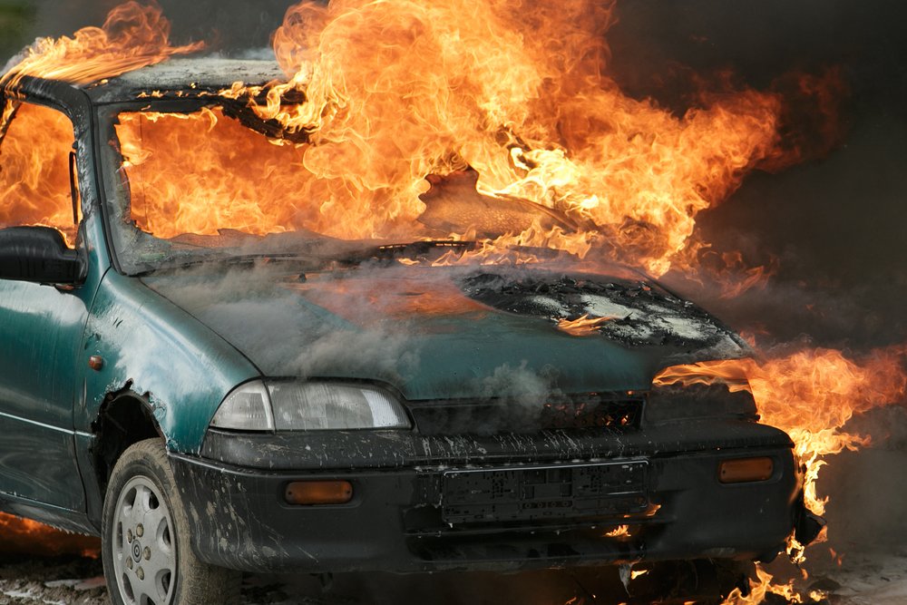 A car in flames as an example of second-degree arson per Colorado 18-4-103 CRS