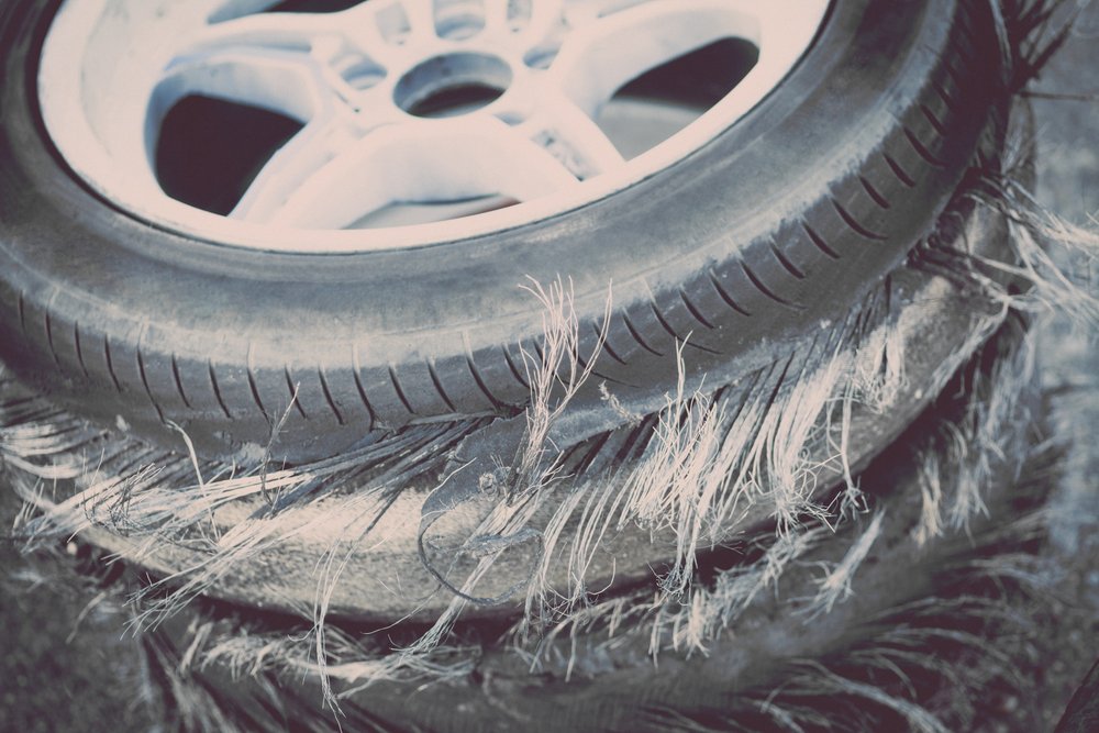 A closeup of a blown out defective tire.