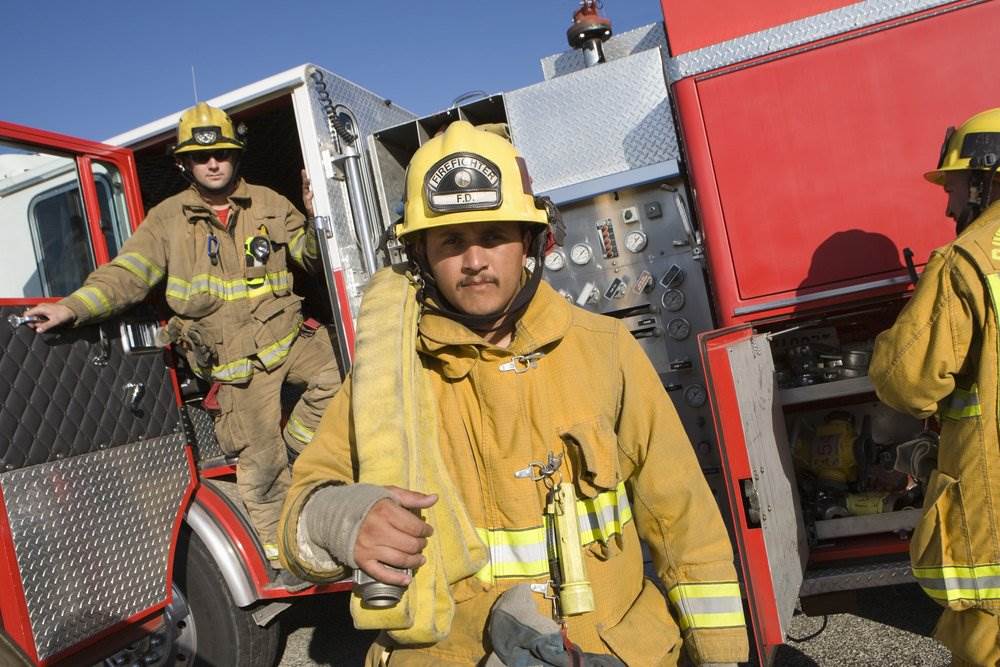 Firefighter exiting the fire engine vehicle.