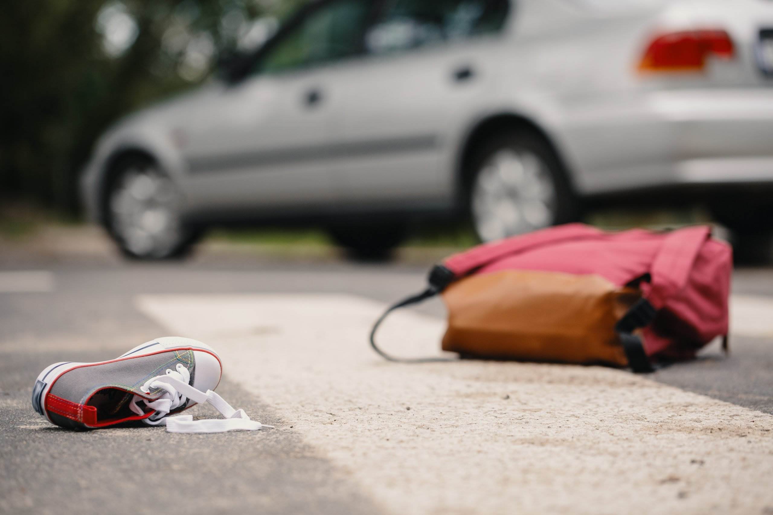 A shoe and a backpack on the ground indicating a pedestrian accident - our Los Angeles pedestrian accident lawyers help victims to sue for compensation