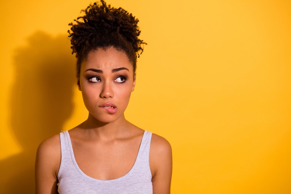 A young woman making an 'oops' face.