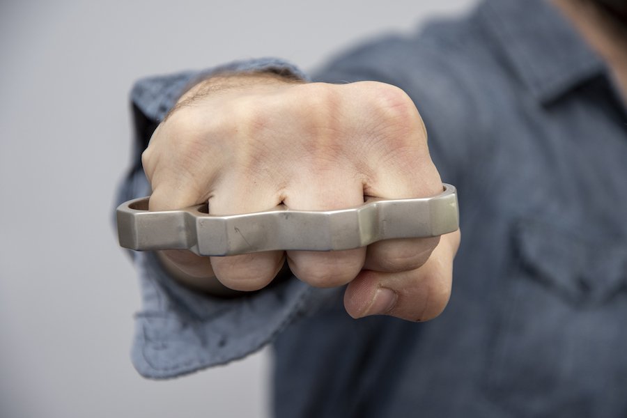Man holding brass knuckles, which are illegal weapons in Nevada