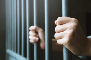 Hands on prison bars after being imprisoned for an NRS 484C.440 violation