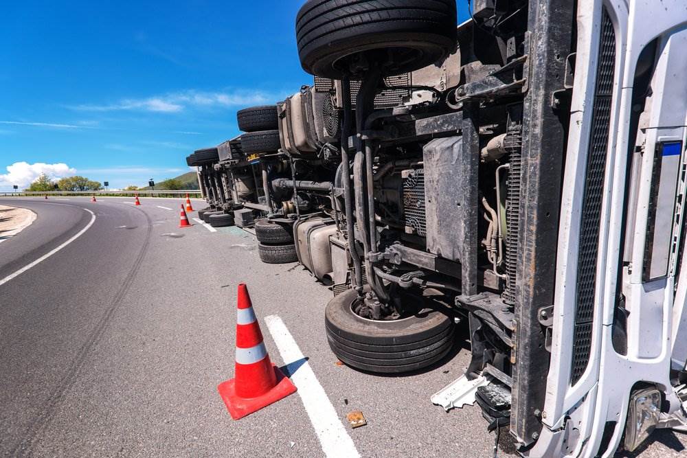 A semi-truck flipped to its side - our California trucking accident lawyers help injury victims to recover compensation