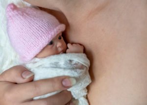 Micro-preemie against mother's chest