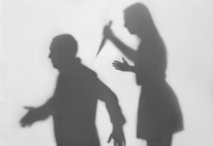 Silhouette of a wife about to stab her husband, which would be prosecuted as homicide in accordance with PC 191