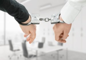 Handcuffs restraining both a principal and accomplice to a crime