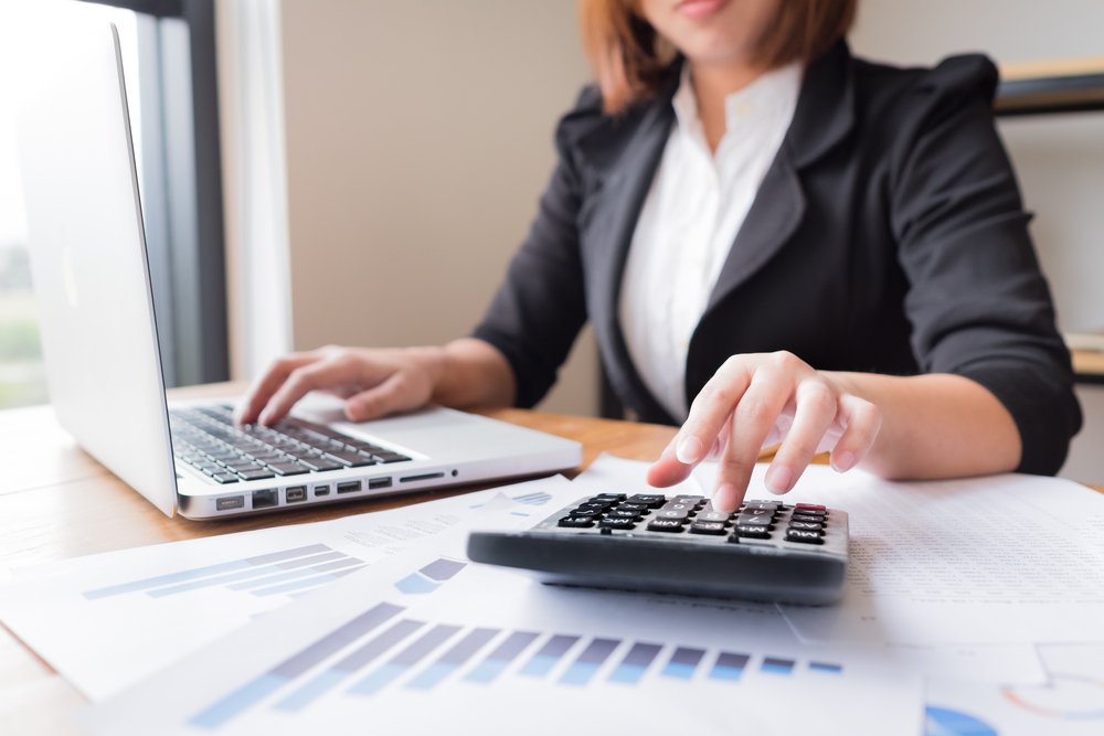 An accountant tapping on her calculator.