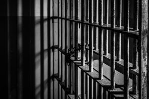 Prison bars representing criminal sentence for racketeerring crime. 