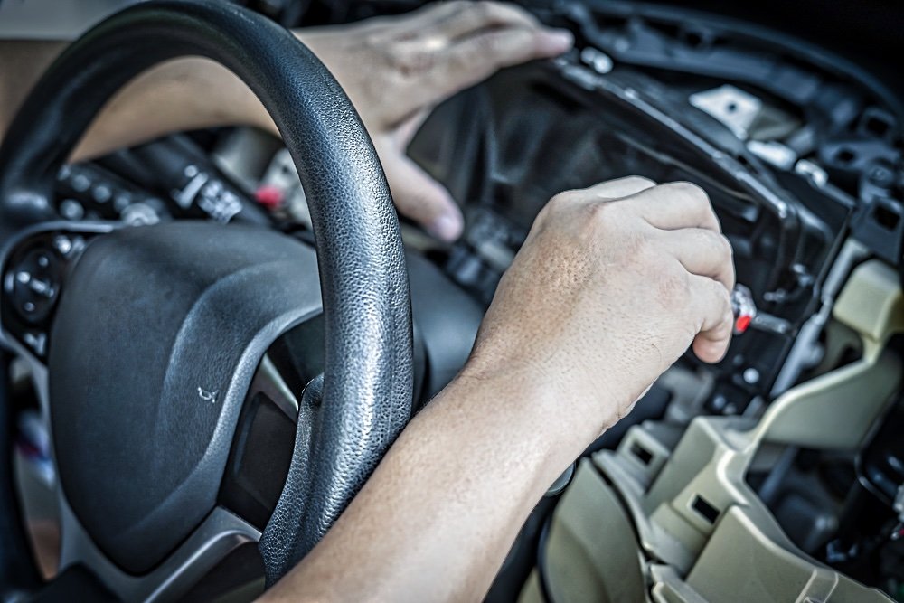 A car's dash being worked on.