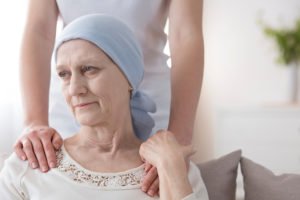 Cancer patient being comforted by caretaker