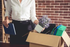 Employee packing away her belongings in a box.