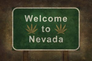 Sign that says "Welcome to Nevada" with marijuana plants