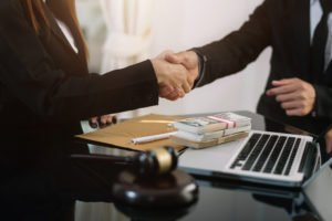 Attorneys shaking hands after reaching a plea bargain.