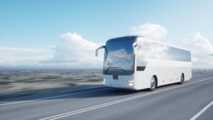 Bus driving on highway with desert in background