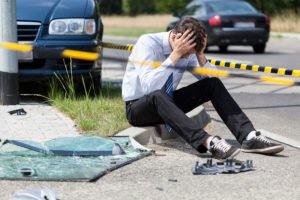 Distraught man on street after causing fatal car accident