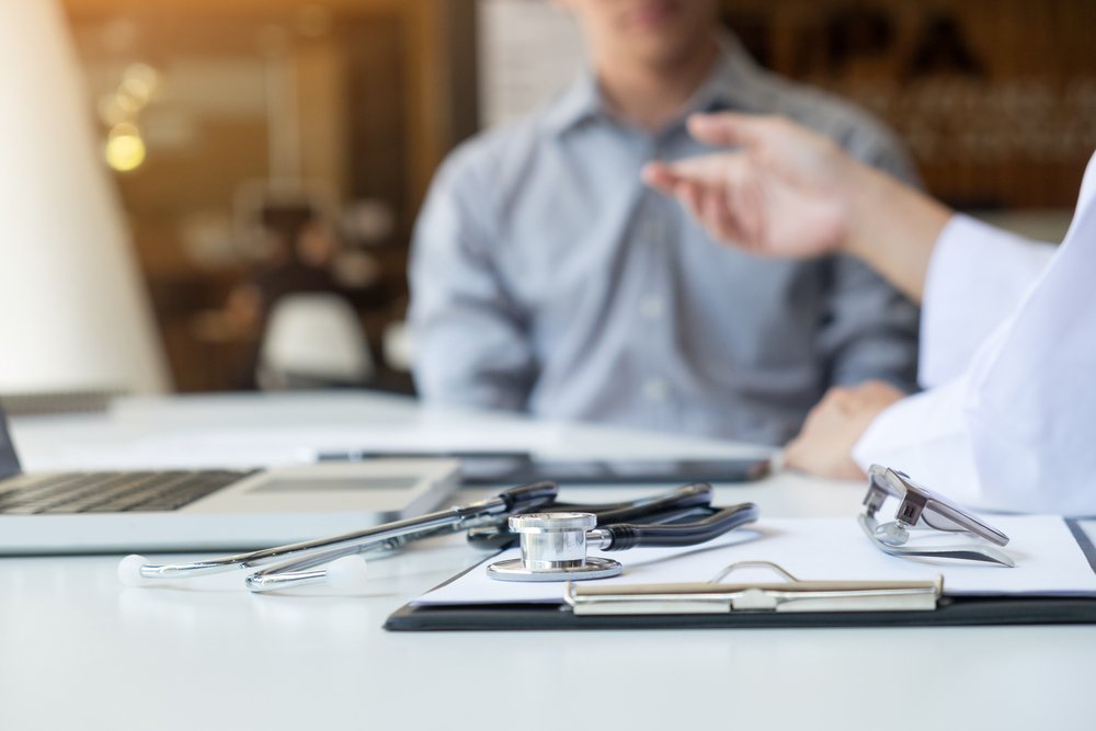 Doctor and patient discussing, potentially about a medical lien.