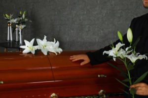 Grieving family mourning over casket 