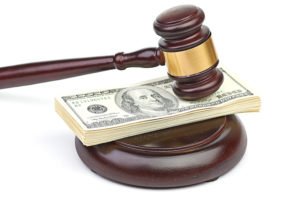 Gavel on a wad of cash, signfiying CC 1431.2's rule that each defendant in a PI cases is responsible for only the non-economic damages he/she caused. 