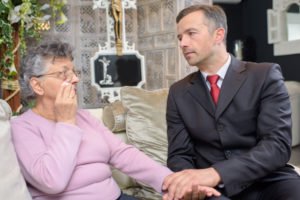 Lawyer comforting widow of wrongful death victim