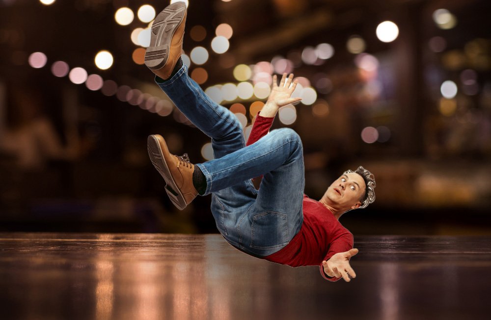 A man slipping at a nightclub or bar.