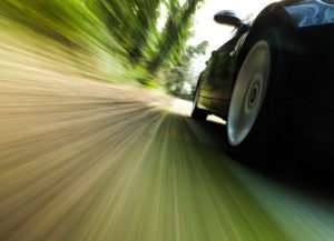 Car speeding on California road in violation of 22352 CVC