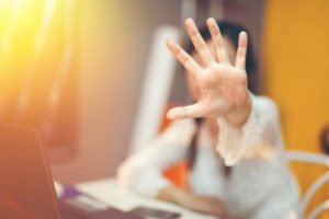 A woman throwing out her hand in a way that suggests "NO, STOP IT!"