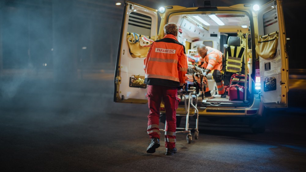 Paramedics entering an ambulance.