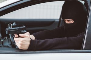 Masked robber shooting a gun from a car with intent to kill in violation of 12022.55 PC.