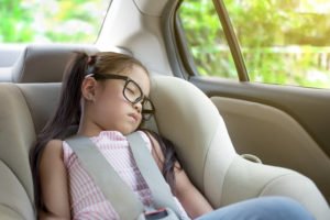 Child asleep in back seat