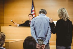 Judge hammering gavel after finding defendant wearing handcuffs in contempt 