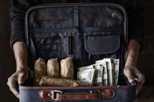 A bag filled with drugs and money, which prosecutors may use as evidence for possession with intent to distribute.