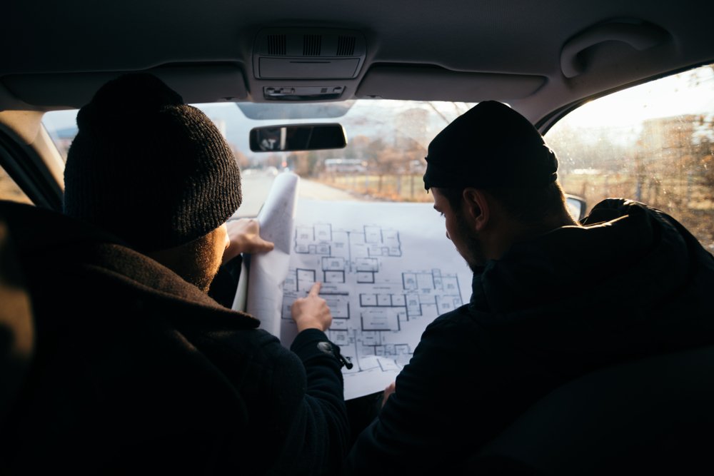 A getaway driver discussing the plans with accomplice.