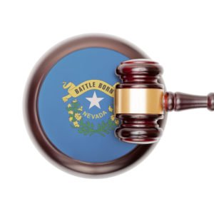 A gavel over the state seal of Nevada.