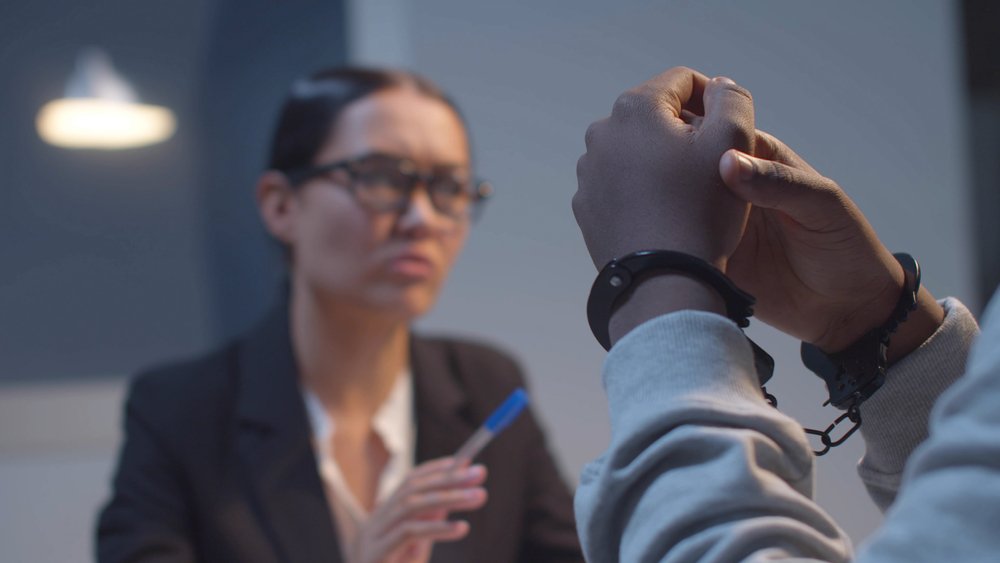 A potential parolee being interviewed by a parole rescission interviewer.