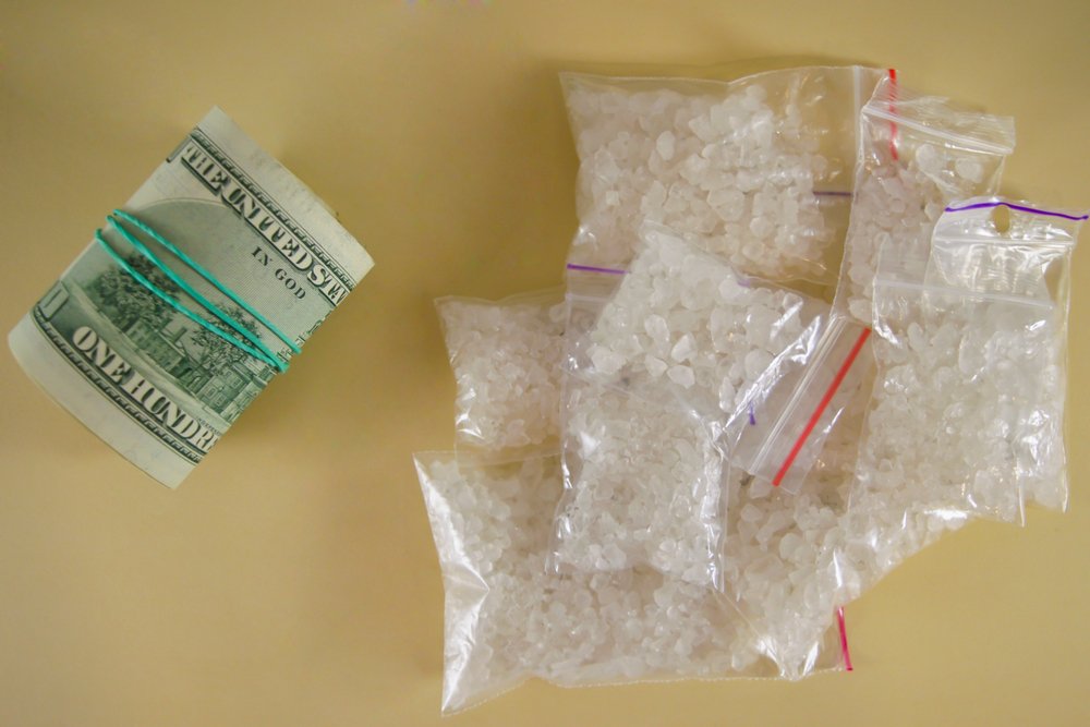 Bags of PCP next to a bundle of money.