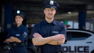 Two police officers crossing their arms.