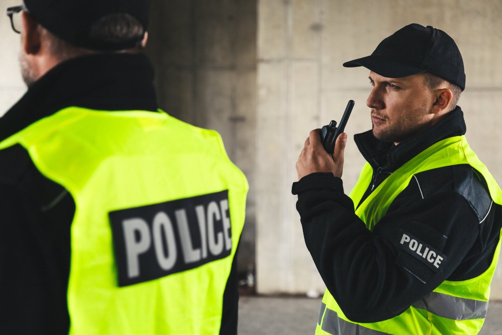 A police officer talking into a walkie talkie.