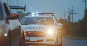 Police officer signalling driver to pull over