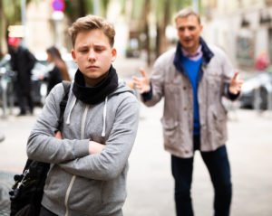 Older man trying to induce a teen boy on the street