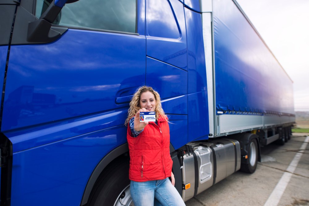 A female truck driver showing her license.