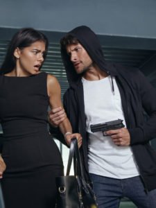 Hooded person with gun intimidating witness with a gun.