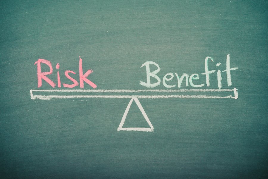 Words "risk" and "benefit" written on chalkboard